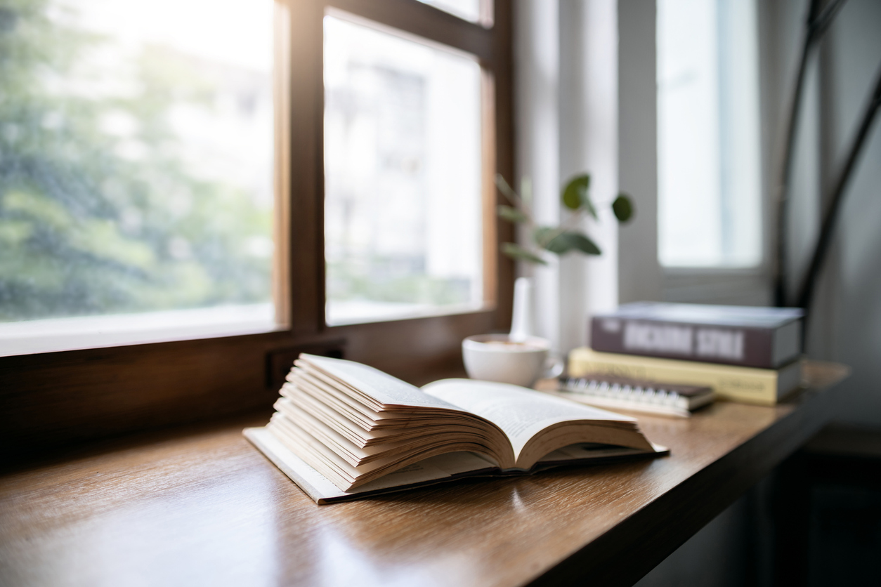 reading book with coffee drink on wooden table